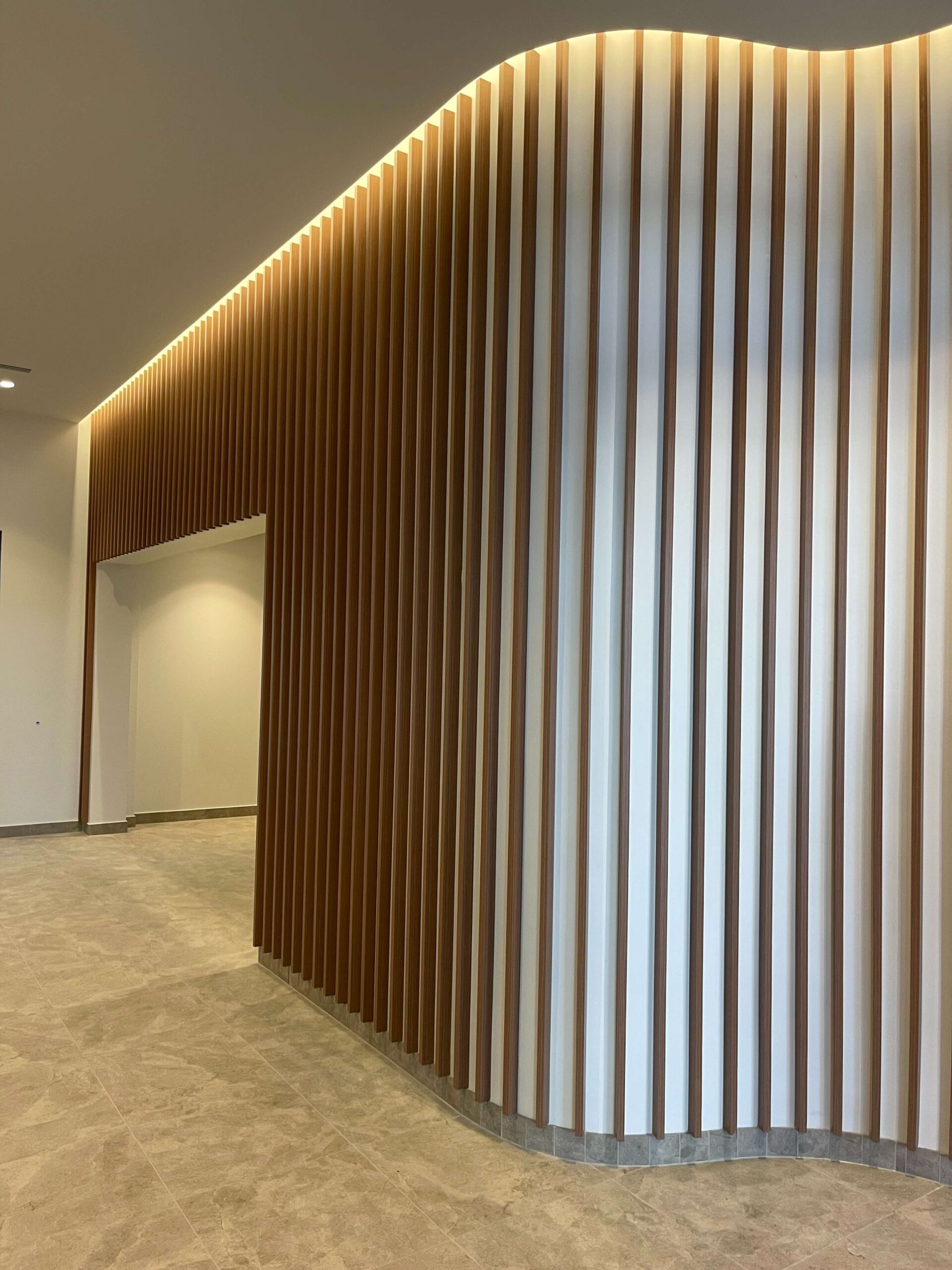 AGG Services showcases a custom aluminium batten curved vertical Knotwood screening.